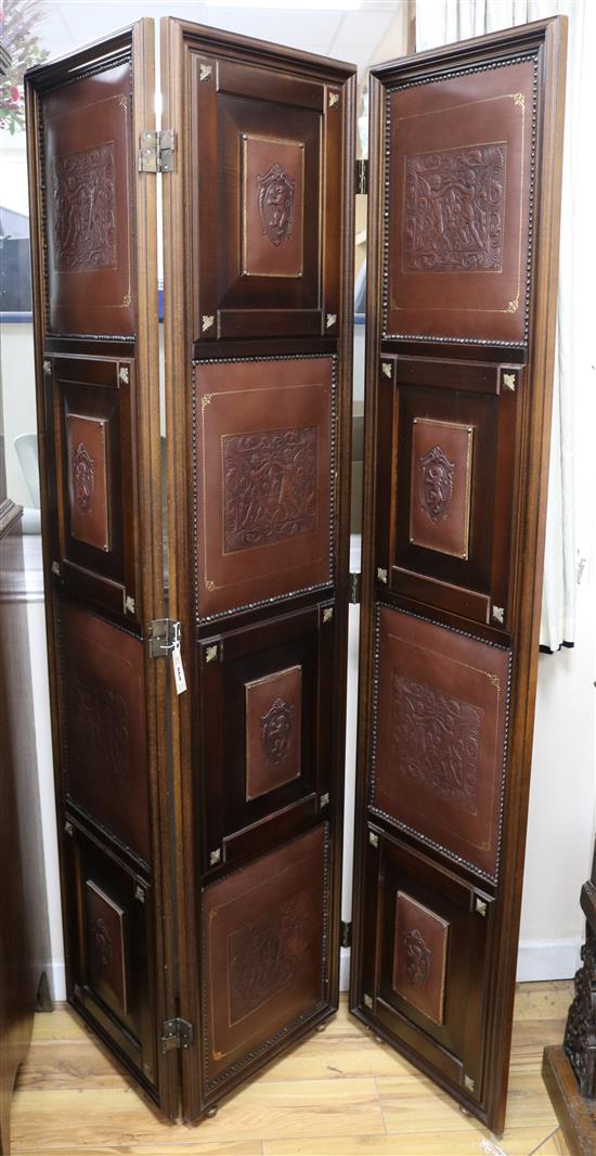 An Edwardian dressing screen with embossed leather panels W.135cm